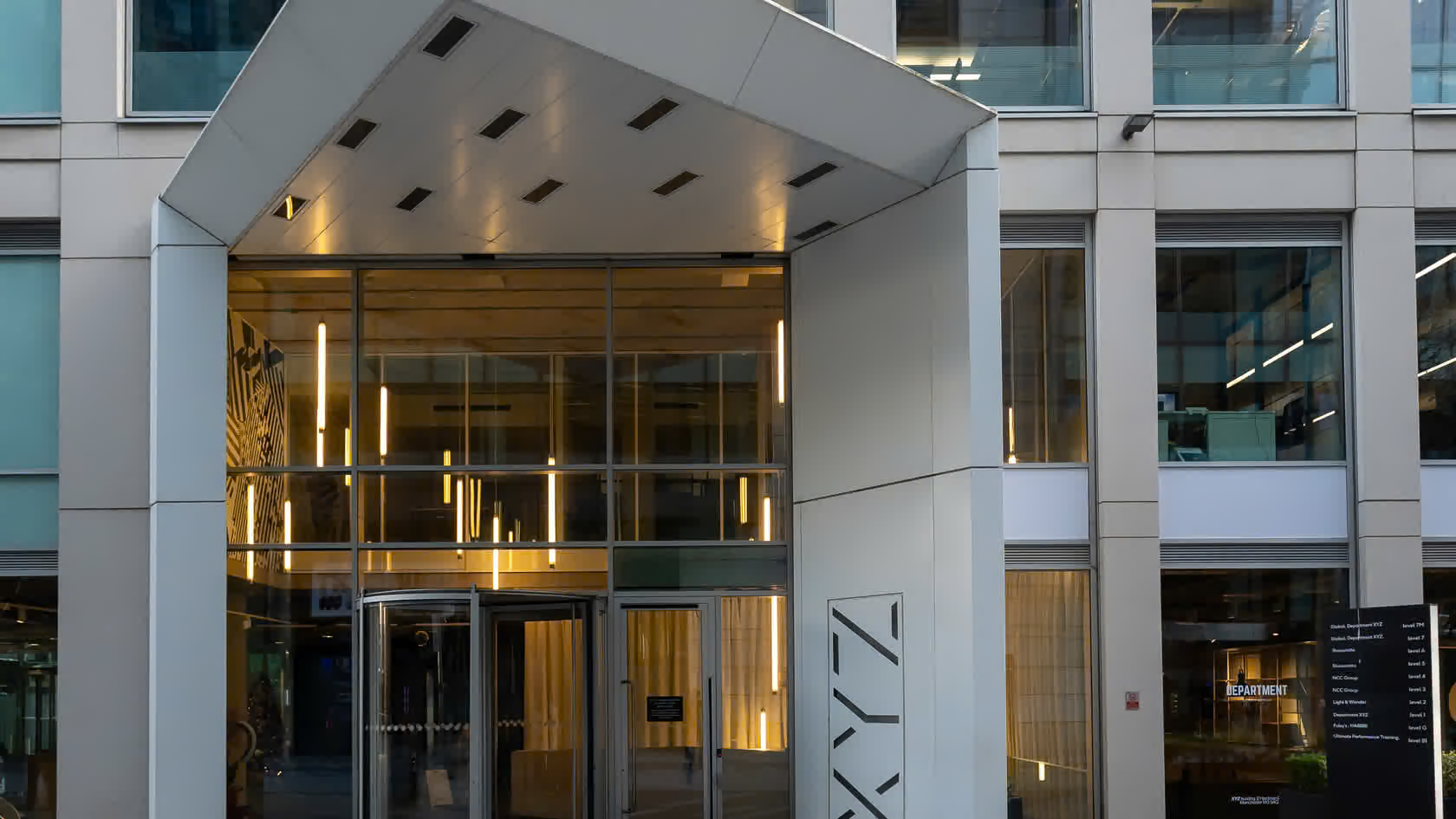 Entrance of a commercial office building with canopy lighting