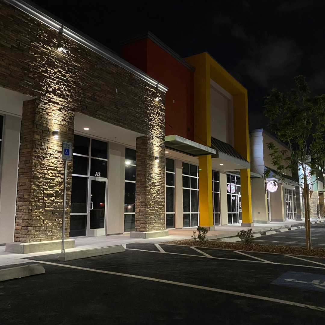 Stone-clad shopfront exterior lit at dusk