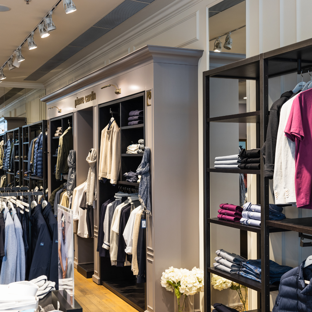 Clothing store interior with lit rails and shelving