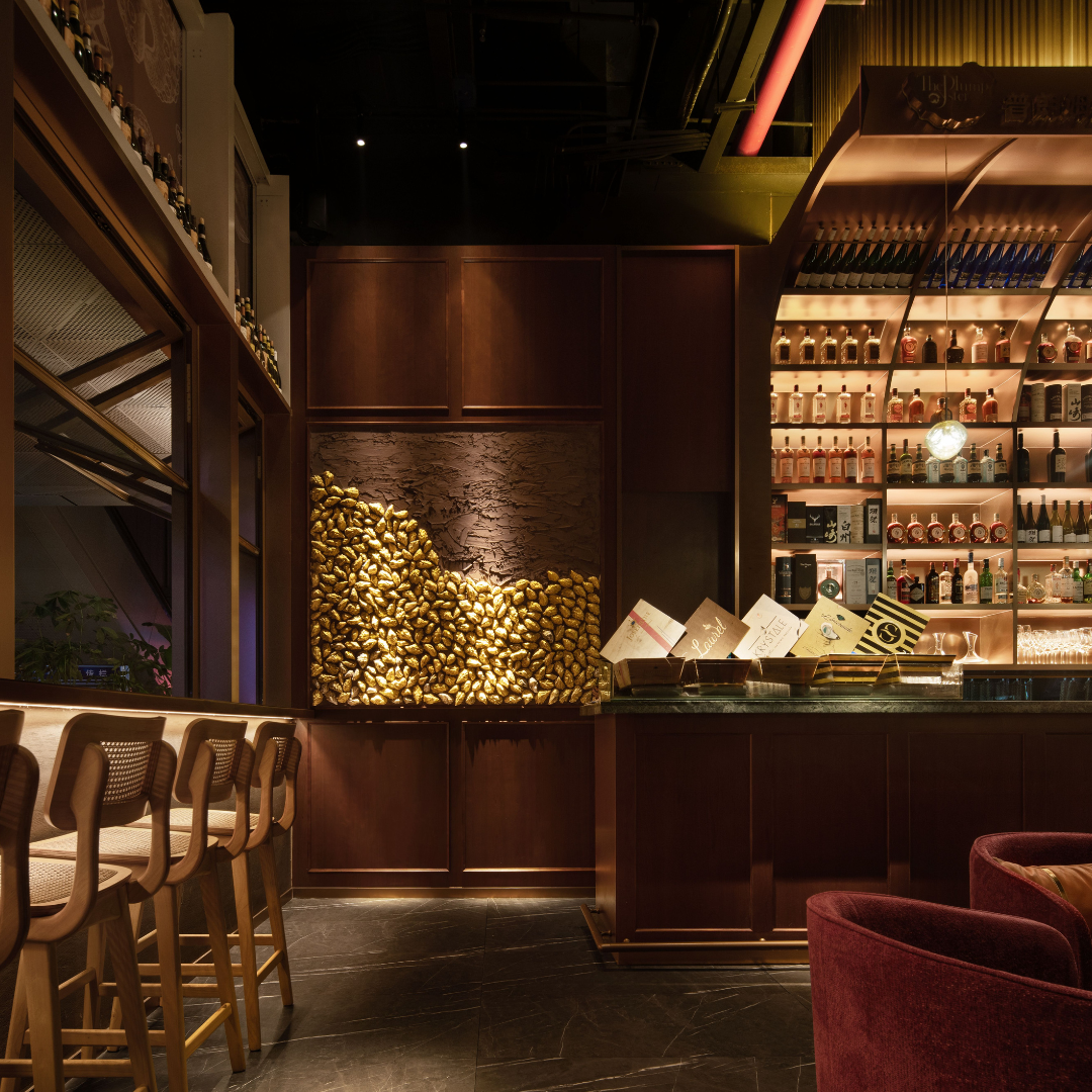 Bar with illuminated back-bar shelving and feature wall