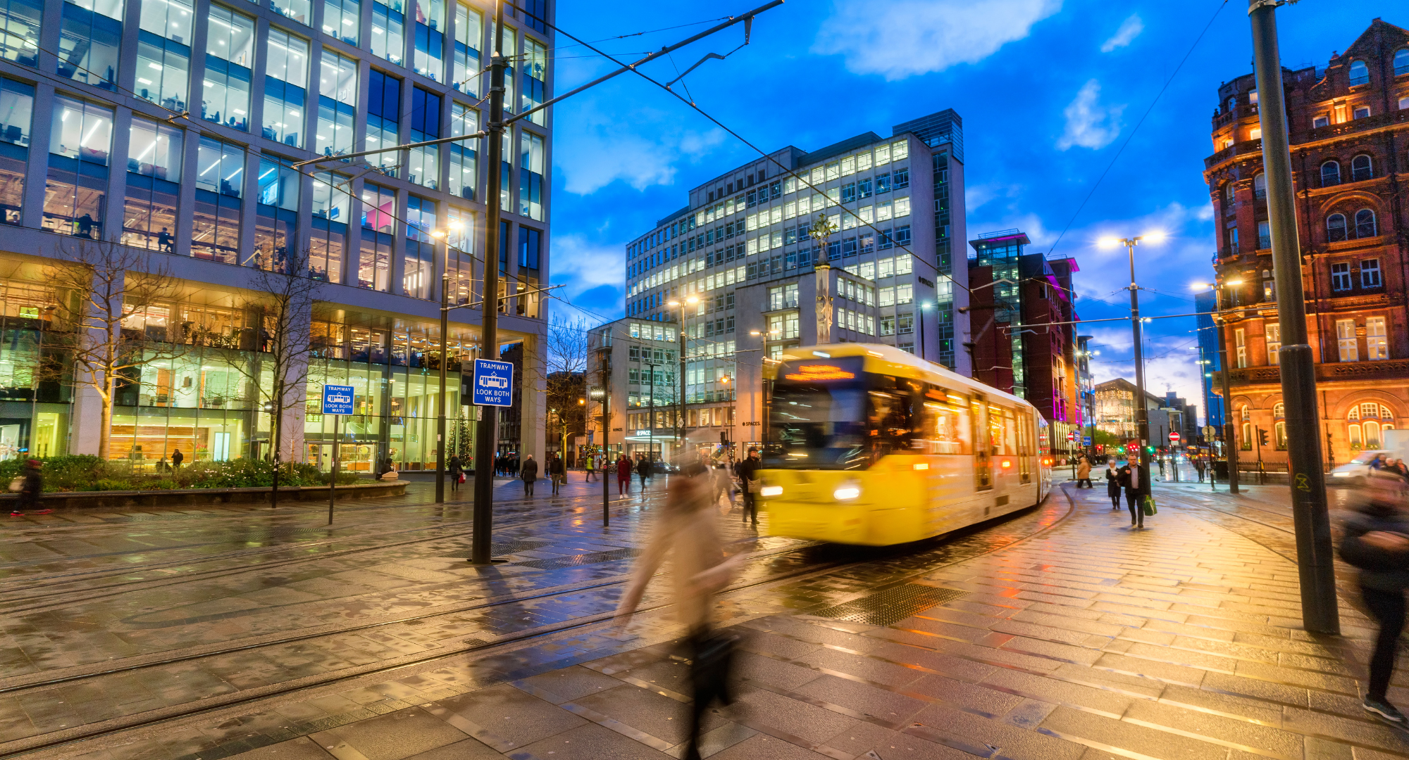 Lit office buildings around St Peter's Square in Manchester city centre at dusk